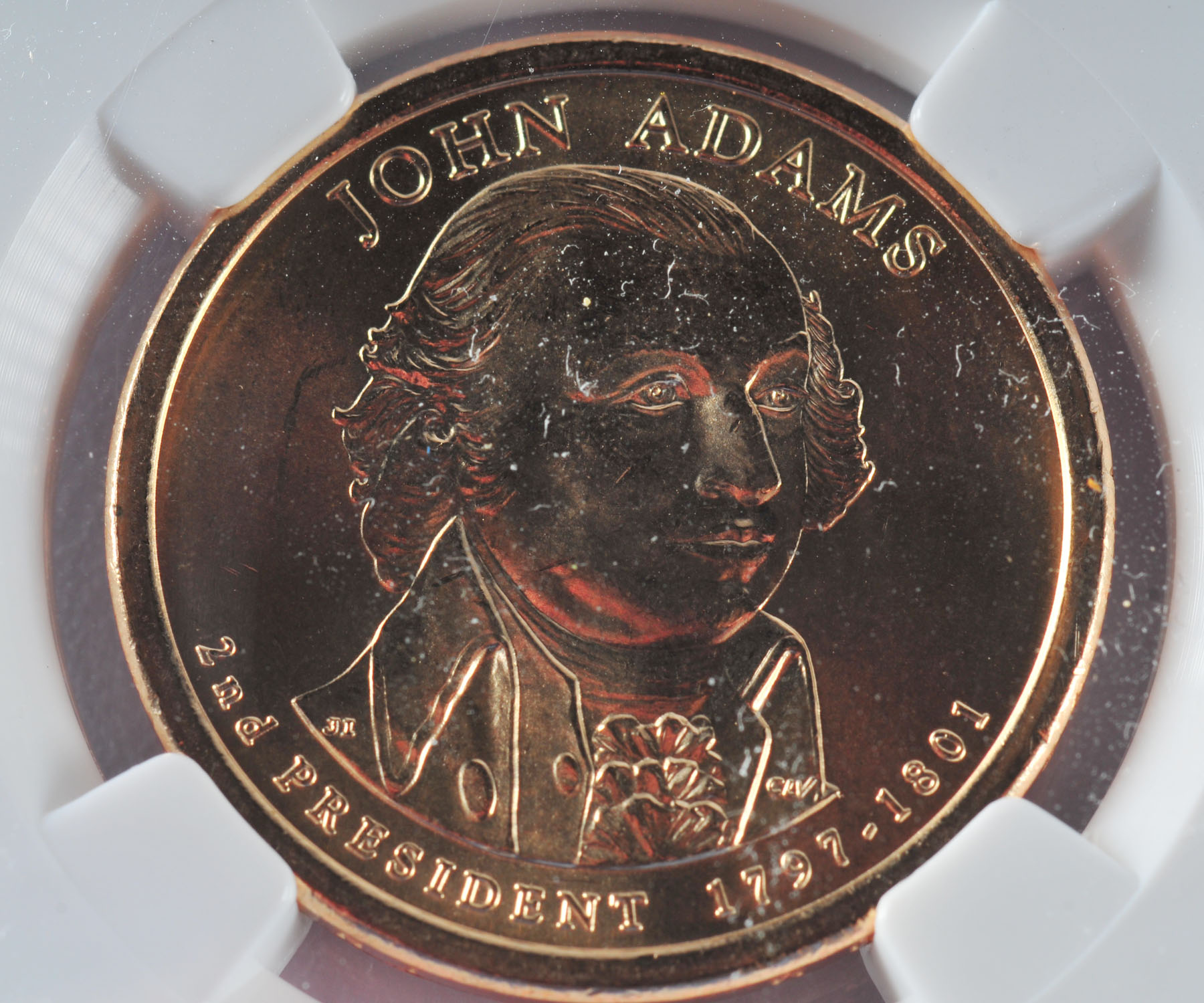 Encapsulated Brilliant uncirculated First Day of Issue (by NGC) 2007 P John Adams Golden one dollar coin