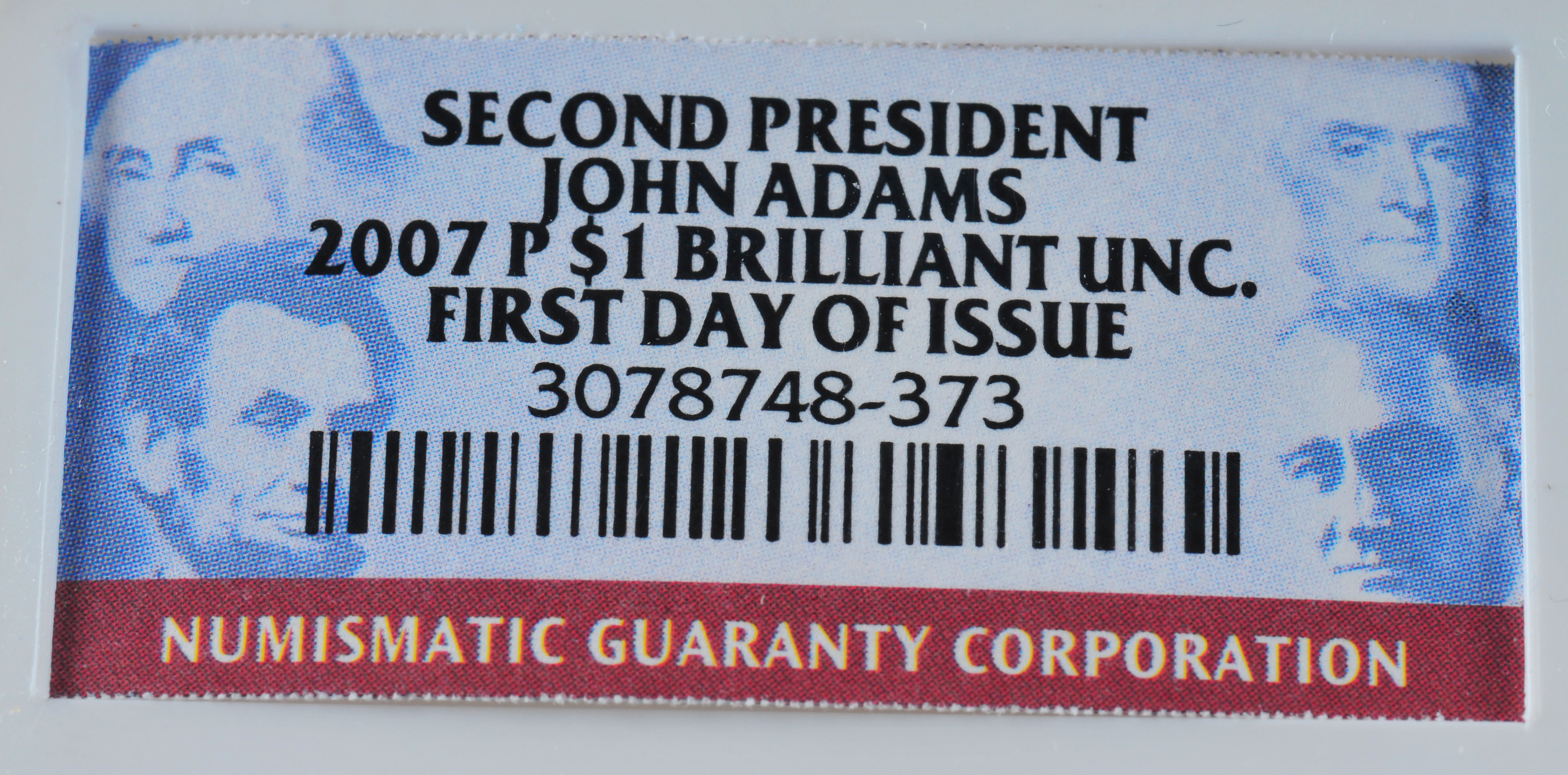 Encapsulated Brilliant uncirculated First Day of Issue (by NGC) 2007 P John Adams Golden one dollar coin