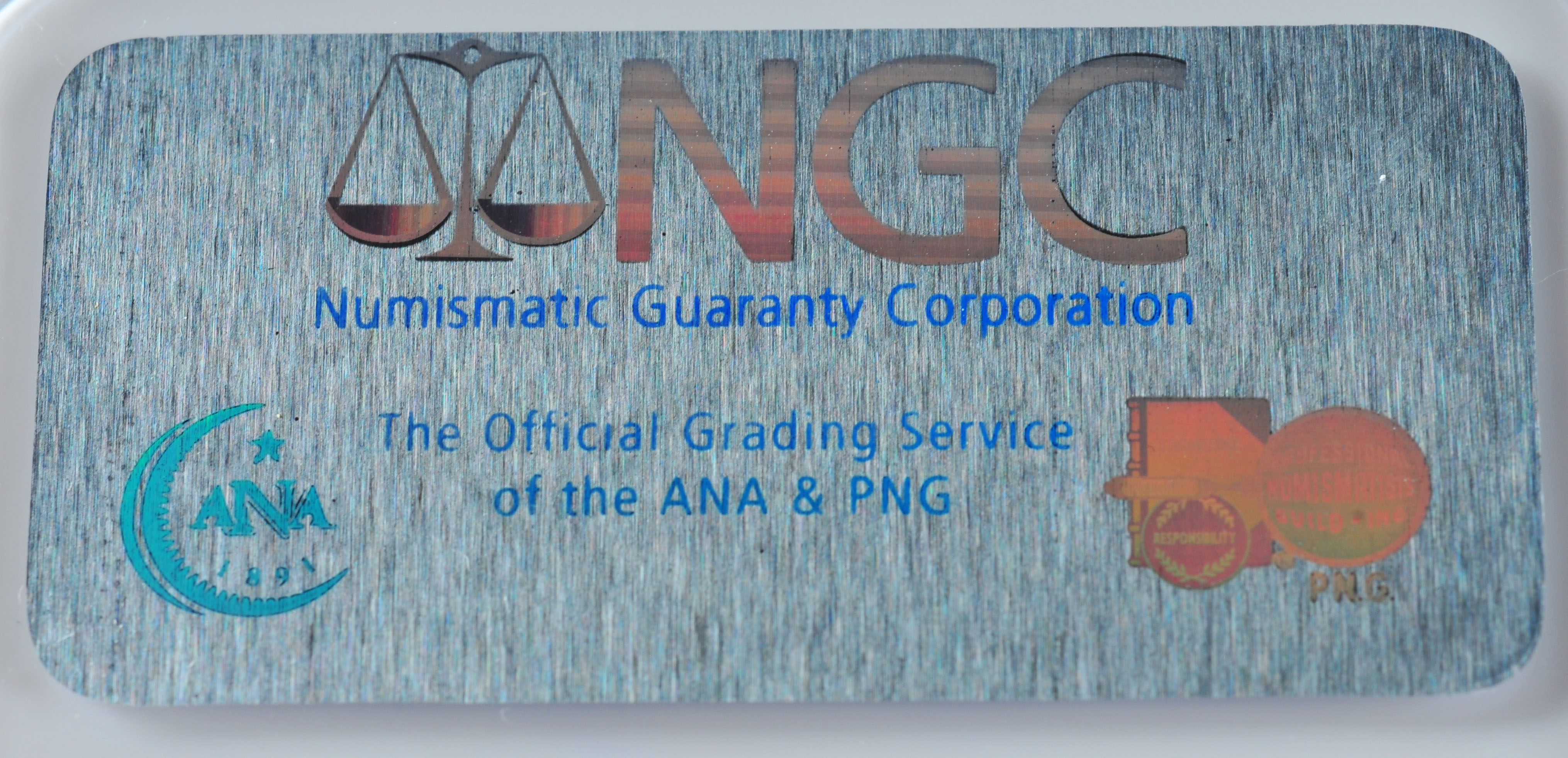 Encapsulated Brilliant uncirculated First Day of Issue (by NGC) 2007 P John Adams Golden one dollar coin