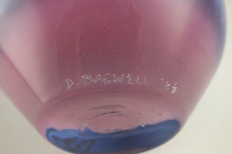 A hand blown colorful art glass vase signed by artist, D. Bacwell