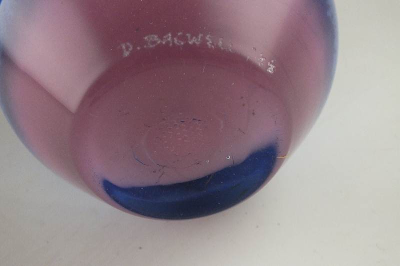 A hand blown colorful art glass vase signed by artist, D. Bacwell