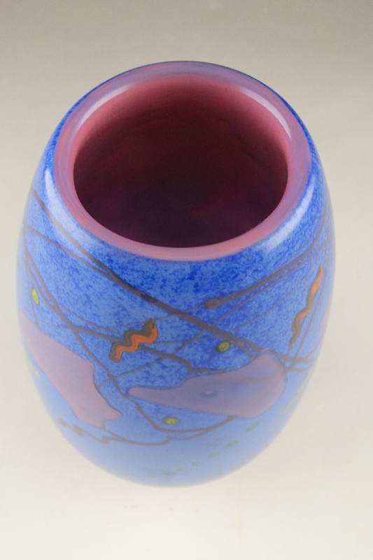 A hand blown colorful art glass vase signed by artist, D. Bacwell