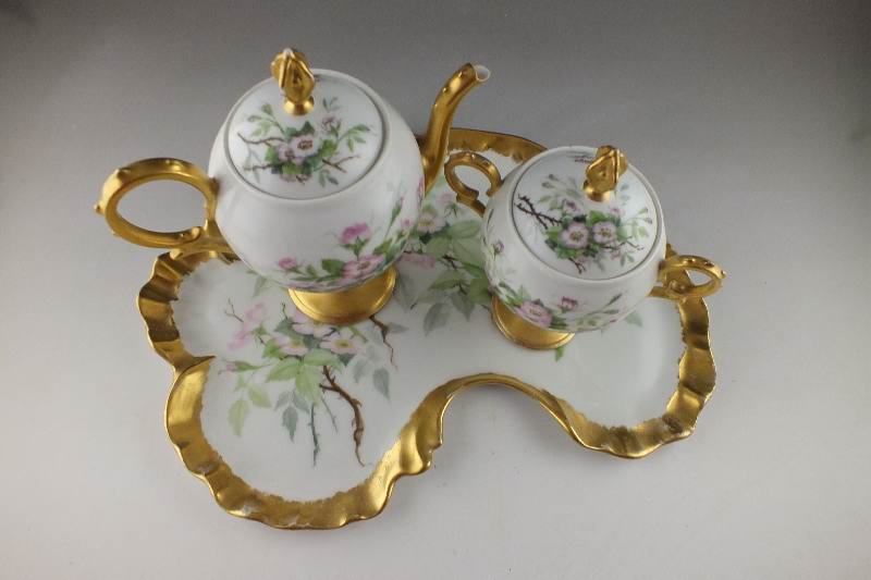 A lovely late 1800's hand painted leaf shaped tray with companion covered sugar bowl and cream pitcher
