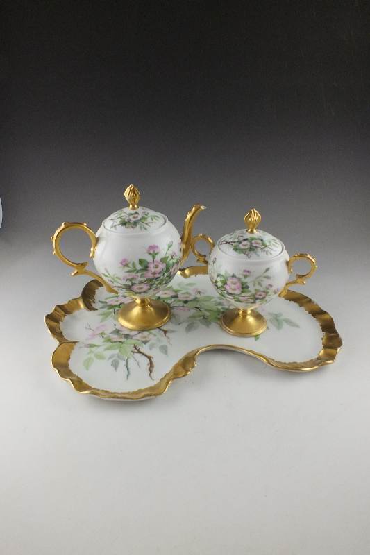 A lovely late 1800's hand painted leaf shaped tray with companion covered sugar bowl and cream pitcher