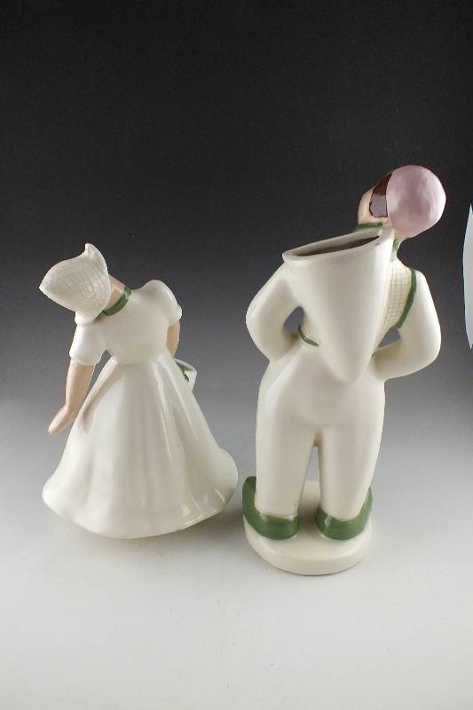A pair of slip cast ceramic Dutch Boy and Girl planter figurines signed by California artist, Hedi Schoop circa  1950's