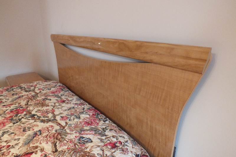 Contemporary style Queen size Qtr. Figured Anigre veneer and laminated woodgrain head board and foot board from USA Pilliod Furniture Inc., Division of Ladd Furniture