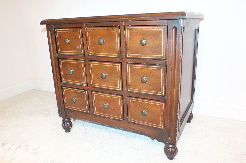 A cute English style chest created from wood veneer accented with a contrasting painted inlay design
