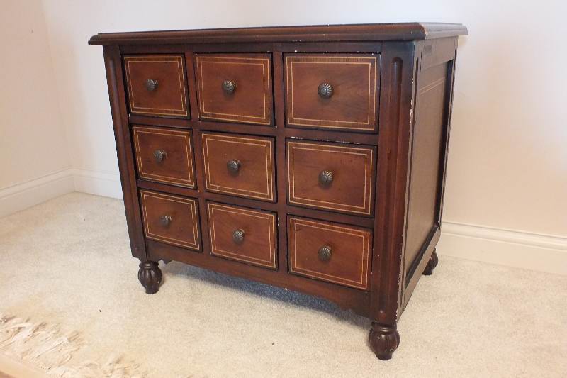 A cute English style chest created from wood veneer accented with a contrasting painted inlay design