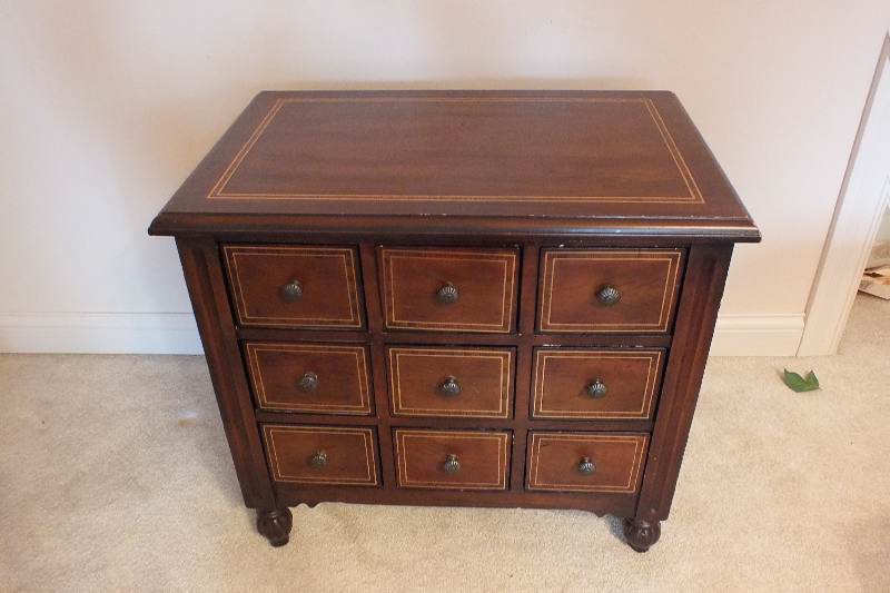A cute English style chest created from wood veneer accented with a contrasting painted inlay design