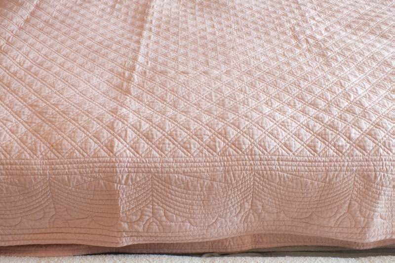 A pair of quilted dusty rose coverlets