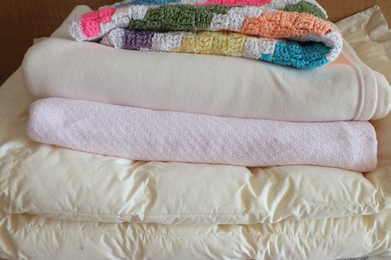 Four assorted twin size blankets