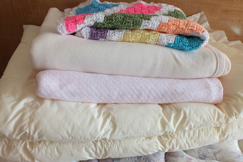 Four assorted twin size blankets