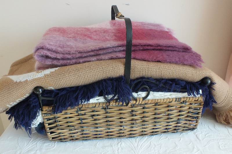 A basket of afghans and throws
