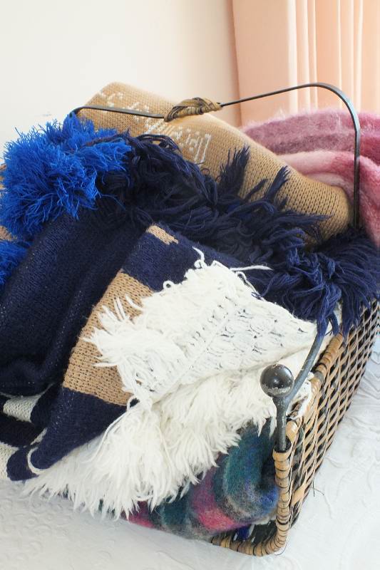 A basket of afghans and throws