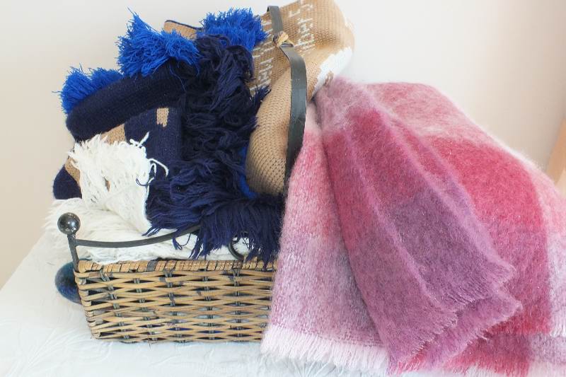 A basket of afghans and throws