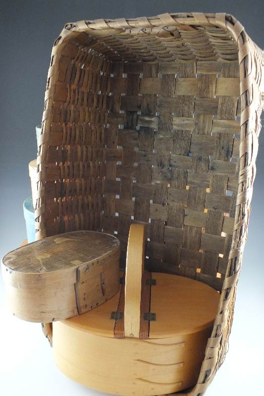 A collection of ten Shaker wooden boxes in assorted sizes and shapes and one Shaker basket