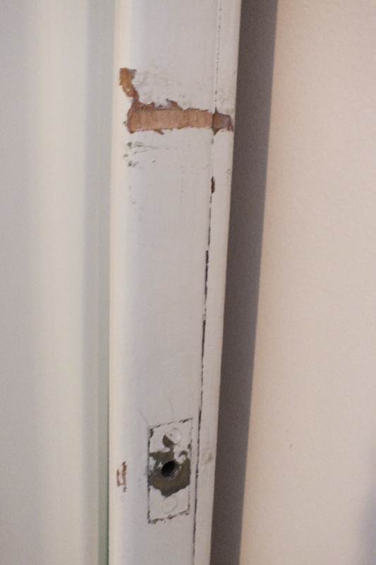 A painted wood framed beveled edge mirror repurposed as a wall unit