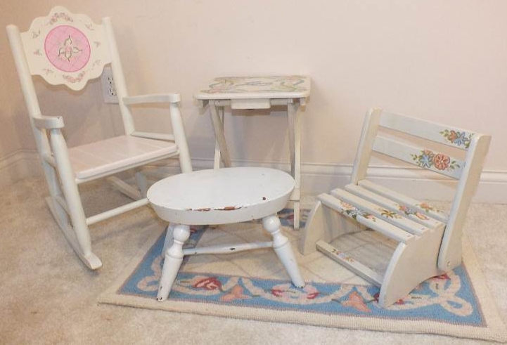 A cute set of furniture which consists of a white wood rocker from Kidcraft, a folding table with a painted "love" design, a vintage wood footstool-nice for reaching the sink, a folding chair stool with hand painted floral appliqués and a small hook rug h