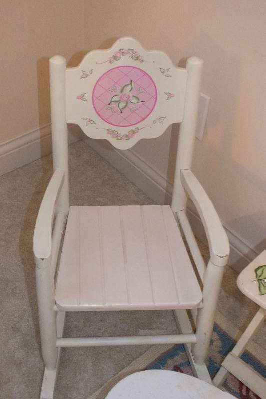 A cute set of furniture which consists of a white wood rocker from Kidcraft, a folding table with a painted "love" design, a vintage wood footstool-nice for reaching the sink, a folding chair stool with hand painted floral appliqués and a small hook rug h