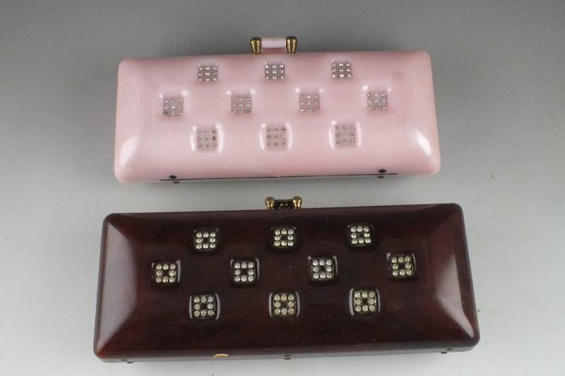 A lovely pink acrylic clutch style purse and a similar style dark amber acrylic purse