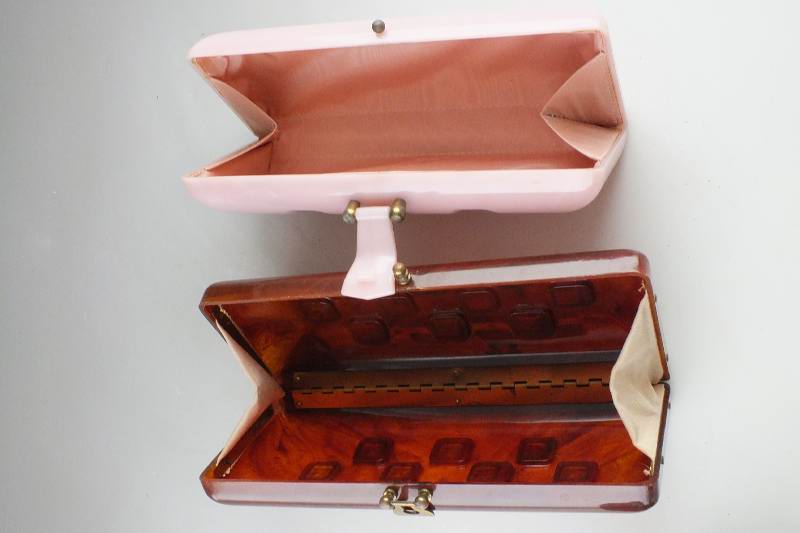 A lovely pink acrylic clutch style purse and a similar style dark amber acrylic purse