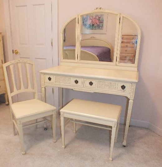 An Italianate style vanity / dressing table with two center dovetail constructed drawers detailed with carved swags and bows