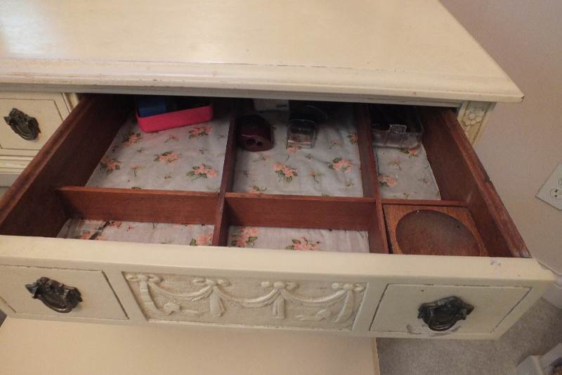 An Italianate style vanity / dressing table with two center dovetail constructed drawers detailed with carved swags and bows