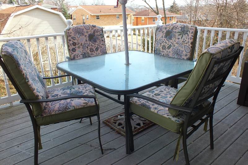 Outdoor dining table with large umbrella and chairs