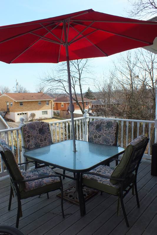Outdoor dining table with large umbrella and chairs