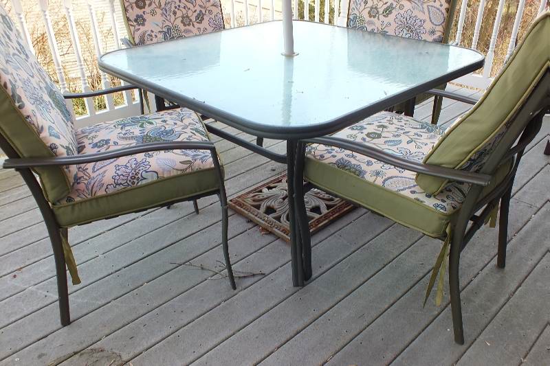 Outdoor dining table with large umbrella and chairs