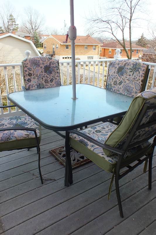 Outdoor dining table with large umbrella and chairs