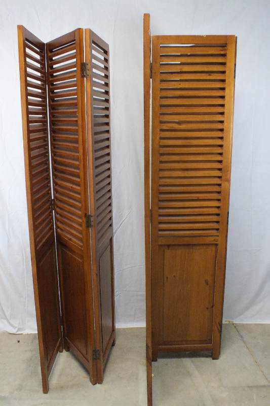 A pair of  louvered wood screens