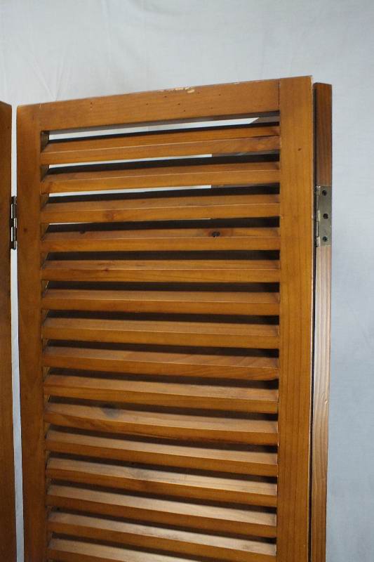 A pair of  louvered wood screens