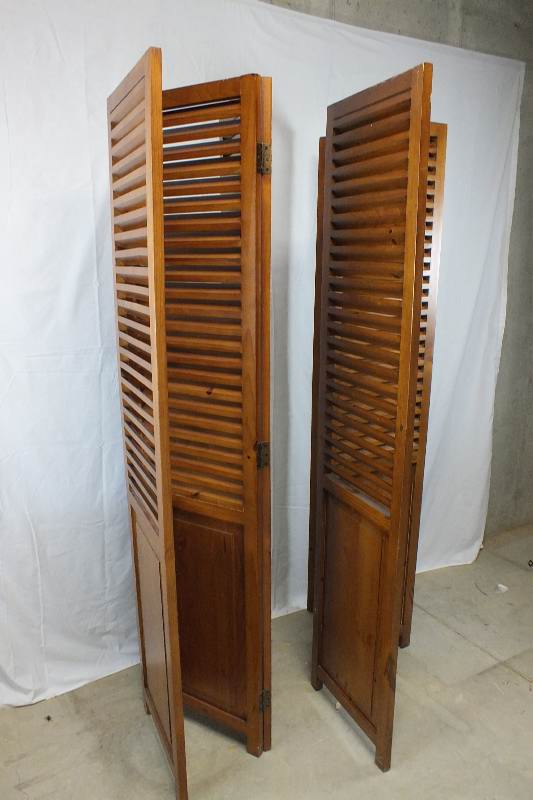A pair of  louvered wood screens