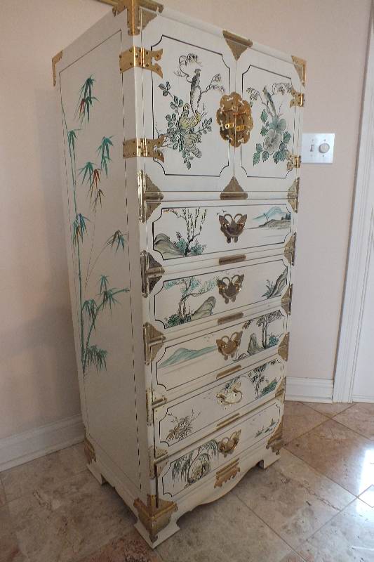 A tall Asian chest of drawers