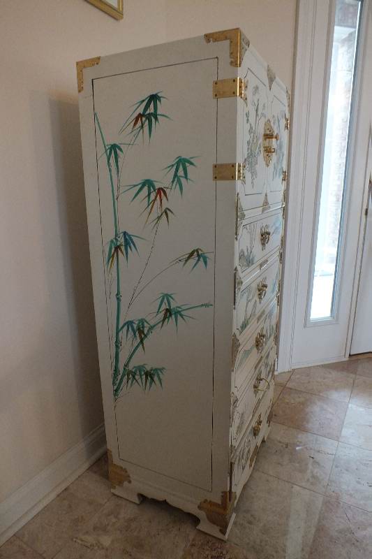 A tall Asian chest of drawers