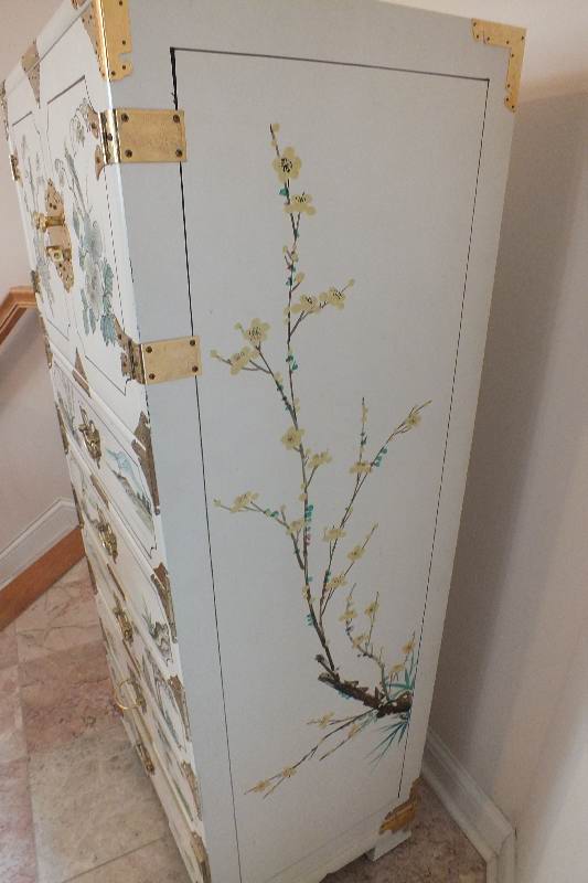 A tall Asian chest of drawers