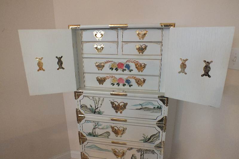 A tall Asian chest of drawers