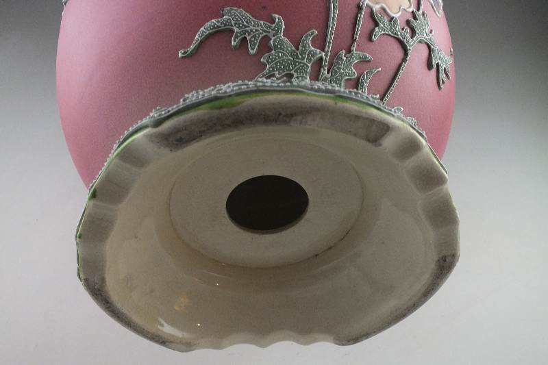 A hand painted and decorated Moriage Lamp in tinted hues of green red blue and grey