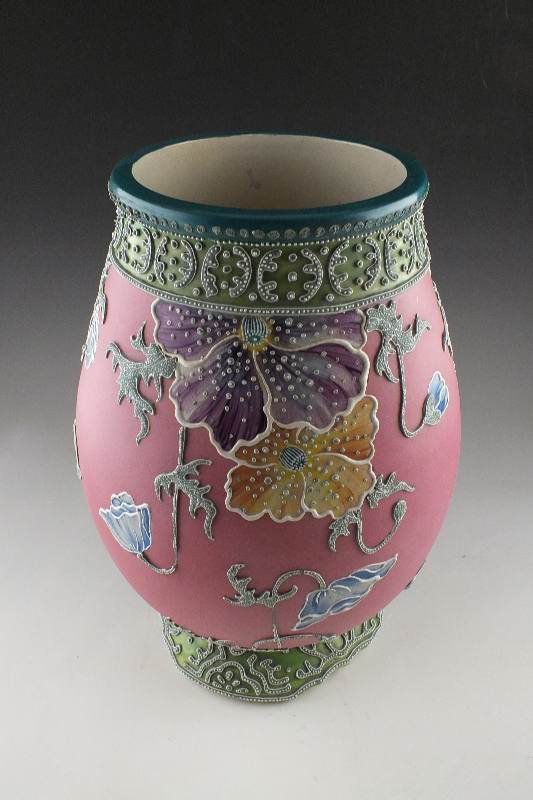 A hand painted and decorated Moriage Lamp in tinted hues of green red blue and grey