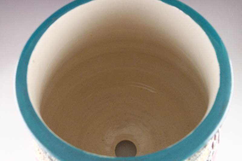 A hand painted and decorated Moriage Lamp in tinted hues of green red blue and grey