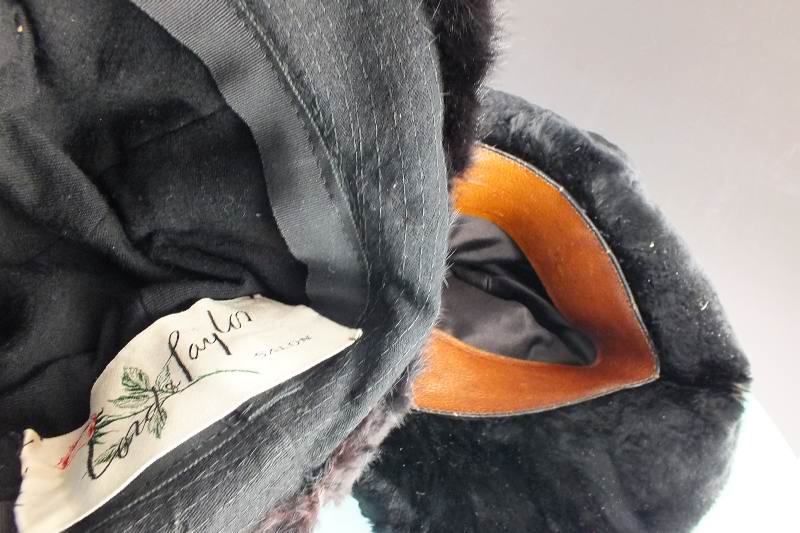 A group of assorted vintage fur Ladies hats in many styles and fur types all are nestled in an acrylic hat box