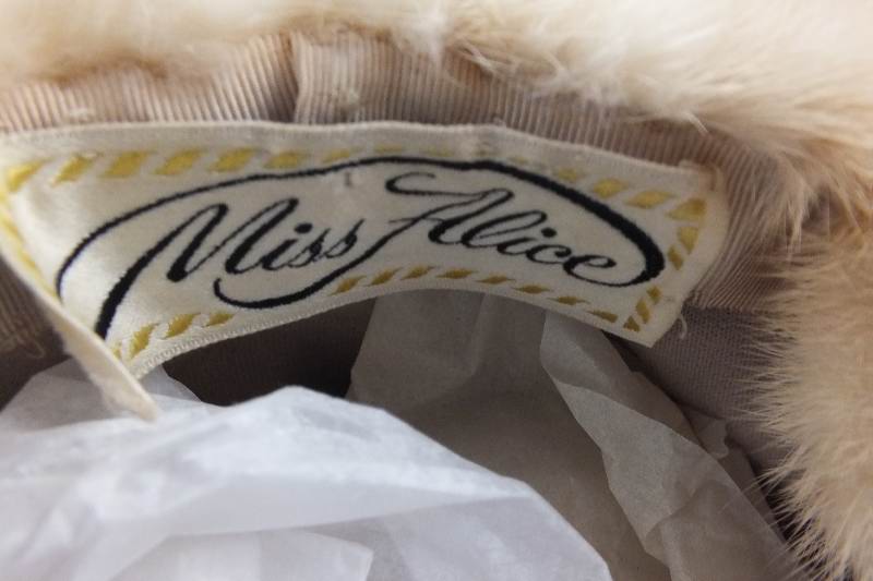 A group of assorted vintage fur Ladies hats in many styles and fur types all are nestled in an acrylic hat box