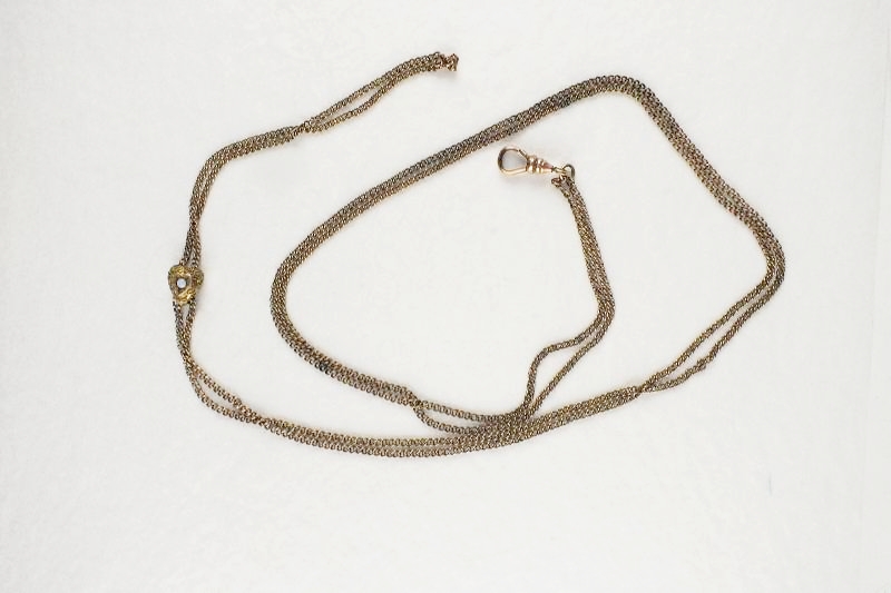 A gold toned Victorian slide necklace with hook clasp marked SHX5