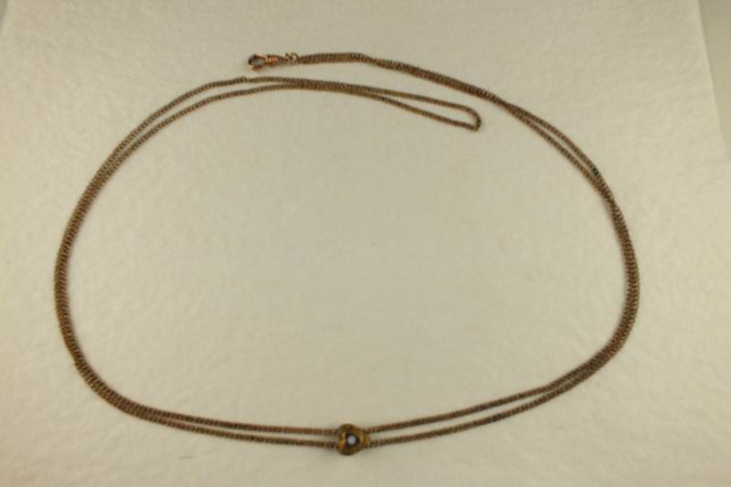 A gold toned Victorian slide necklace with hook clasp marked SHX5