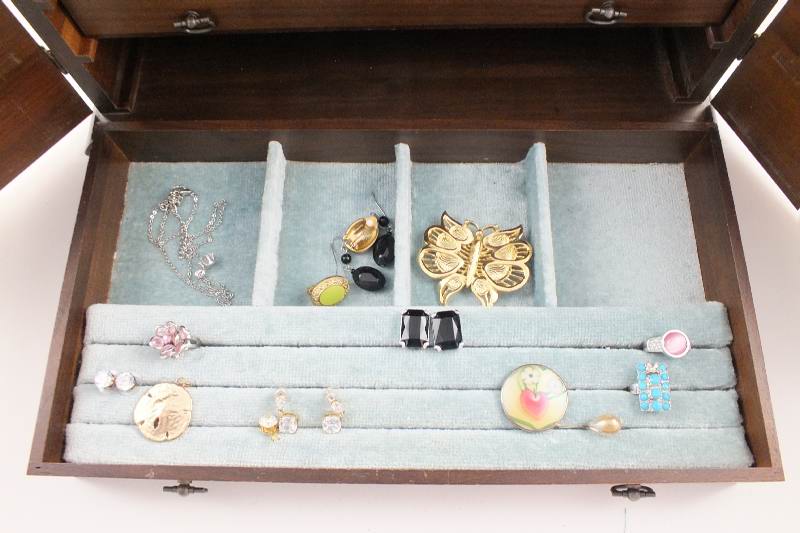 A walnut jewelry chest with two cabinet doors