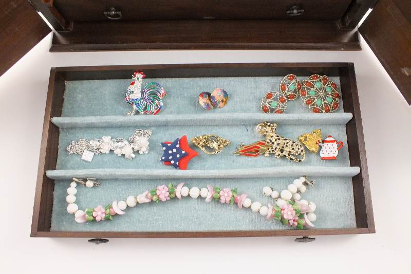 A walnut jewelry chest with two cabinet doors