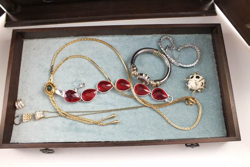 A walnut jewelry chest with two cabinet doors