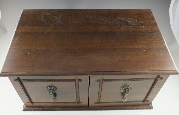 A walnut jewelry chest with two cabinet doors
