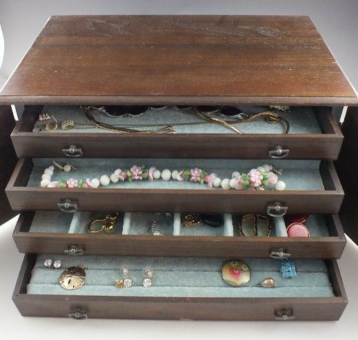 A walnut jewelry chest with two cabinet doors